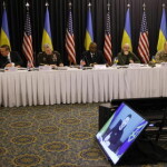 epa10417453 Ukrainian President Volodymyr Zelensky speaks on a video screen to participants of the third meeting of Ukraine Defense Contact Group at the US Air Base in Ramstein, Germany, 20 January 2023. The US Secretary of Defense Lloyd Austin has invited Ministers of Defense and senior military officials from around the world to Ramstein to discuss the ongoing crisis in Ukraine and various security issues facing US allies and partners.  EPA/RONALD WITTEK
